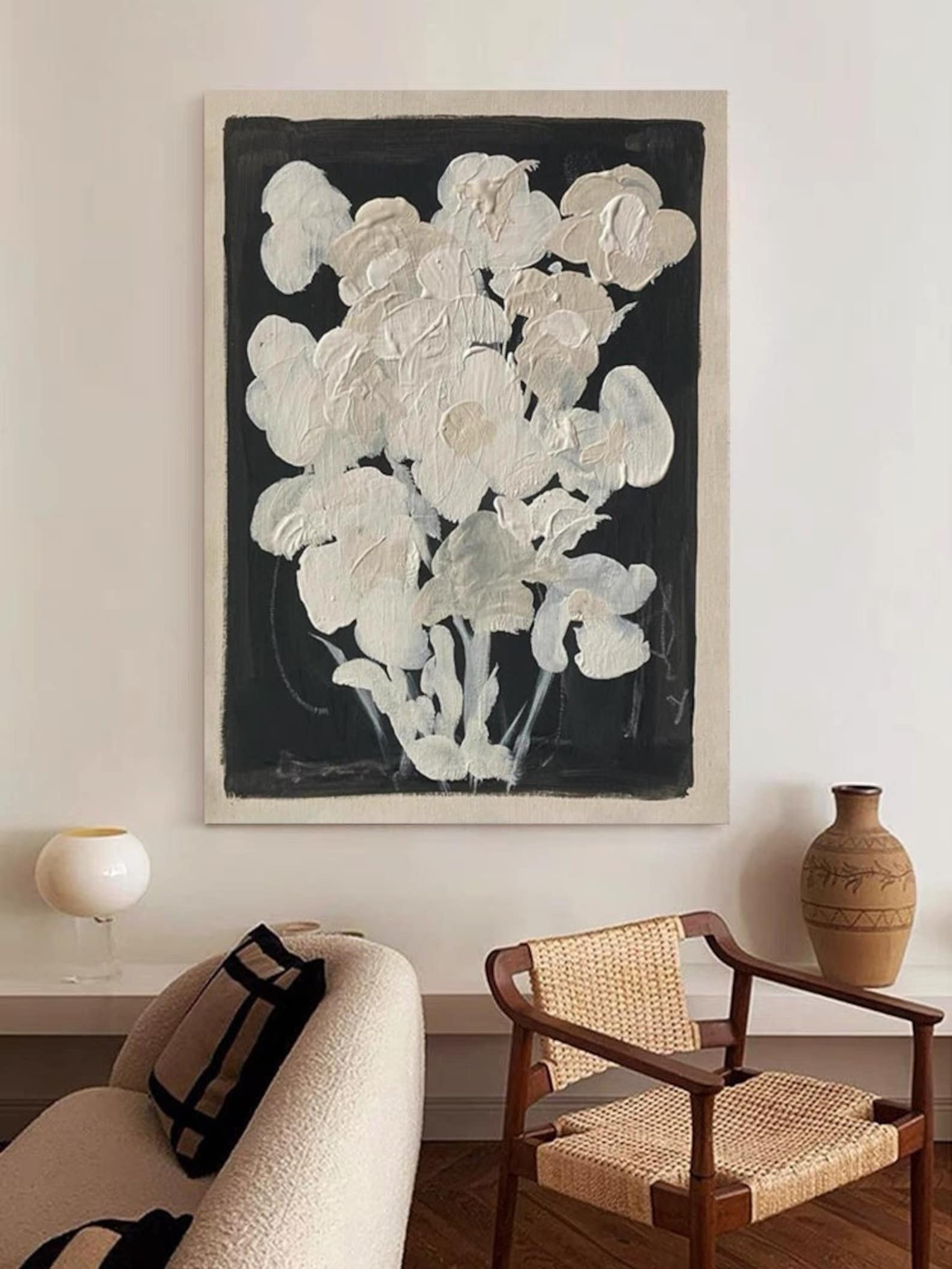 Mid-century modern inspired wall art featuring a delicate white floral design against a black background, ideal for living rooms or bedrooms.