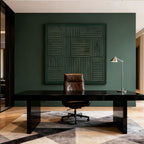 3D textured dark green geometric wall art with woven patterns, Wabi-Sabi style, displayed in a contemporary office with dark desk, brown leather chair, and silver lamp.