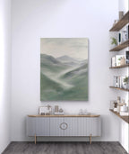 Green abstract mountain landscape painting, depicting misty mountains with soft green, grey, and white tones, adding tranquility and a natural touch to modern decor.