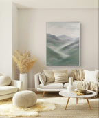 Green abstract mountain landscape painting, depicting misty mountains with soft green, grey, and white tones, adding tranquility and a natural touch to modern decor.