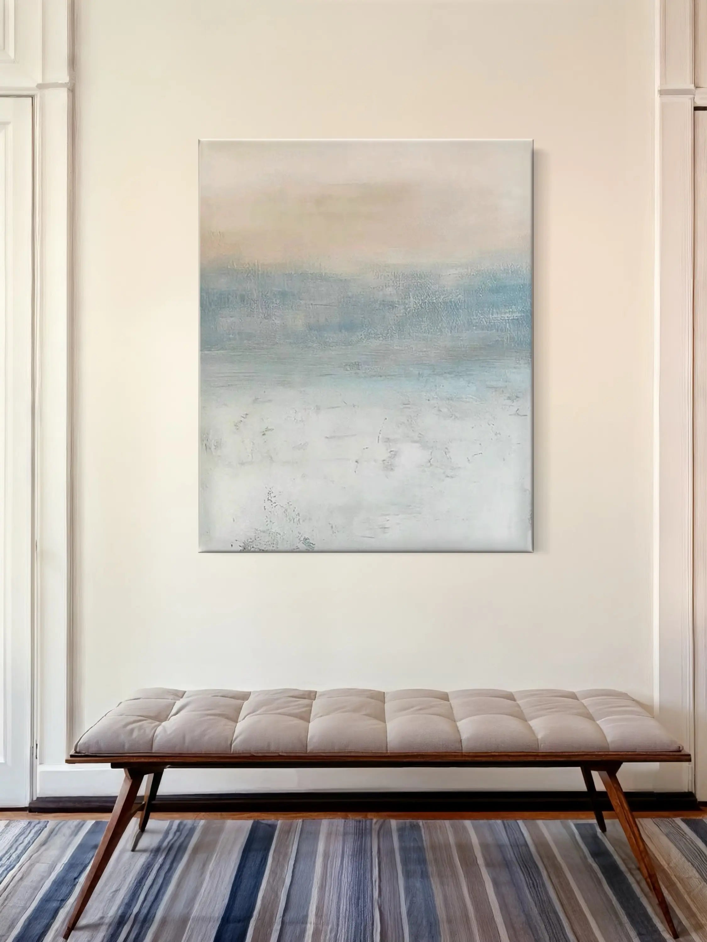 Abstract landscape painting with soft blue, beige, and white tones, creating a calming atmosphere.
