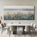 Impressionist floral landscape painting with blue/orange wildflowers, sandy beach, ocean horizon, textured brushstrokes, hanging in modern dining room
