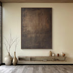Japandi Wabi-Sabi minimalist abstract canvas wall art in earthy browns, mounted above minimalist shelf with decorative vases, living room decor