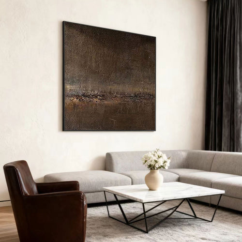 Modern living room with a gray sofa, brown armchair, marble coffee table, and abstract painting.