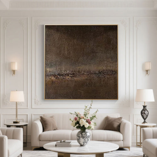 Modern living room with a large abstract painting on the wall, white sofa, and decorative elements.