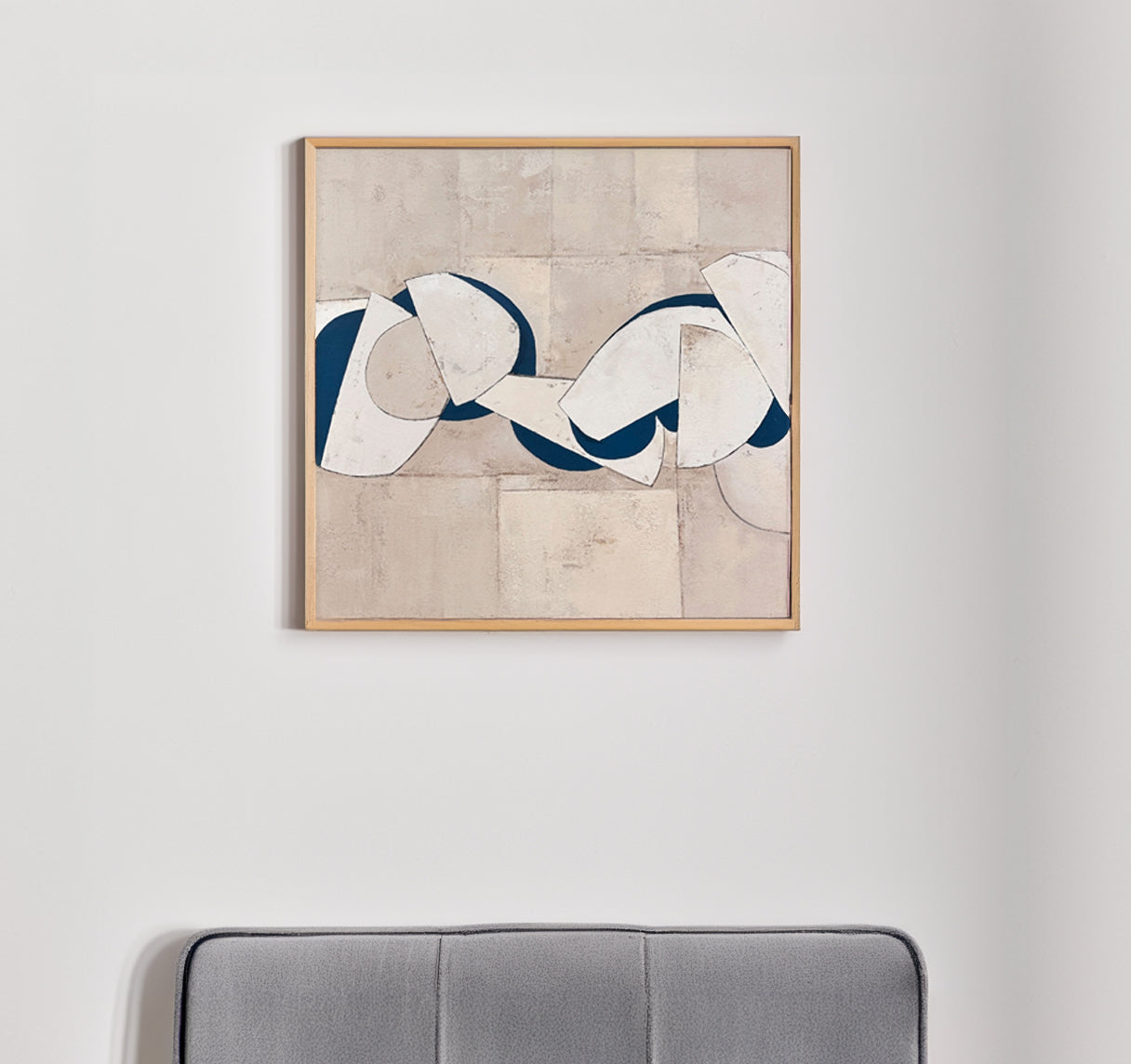 Beige abstract geometric art with blue accents in a staged living room.