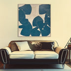 Abstract teal and beige art displayed above a vintage style couch.