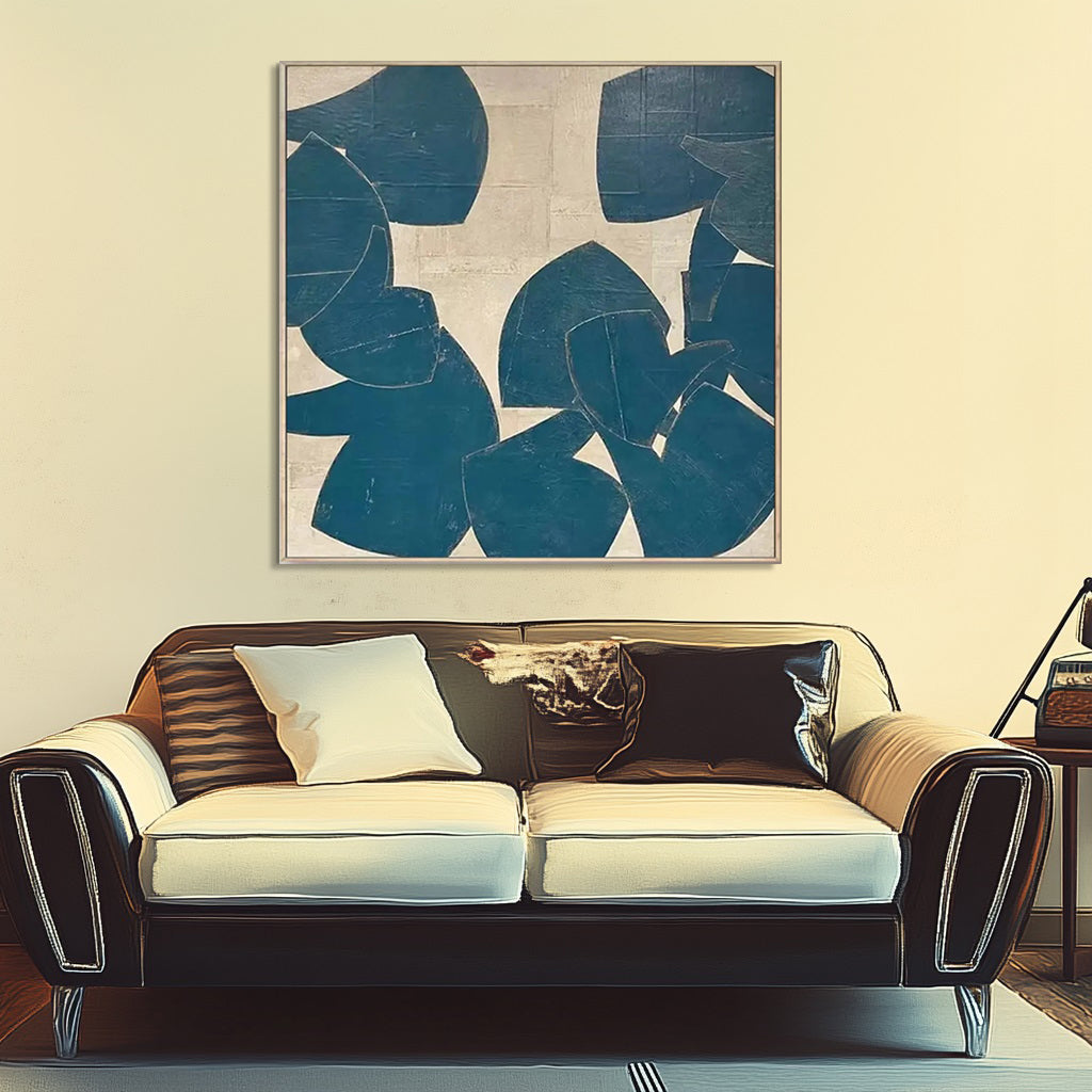 Abstract teal and beige art displayed above a vintage style couch.