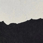 Close-up of black and white minimalist abstract beach painting.