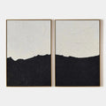 Two minimalist abstract beach paintings in gold frames, black and white canvas art.