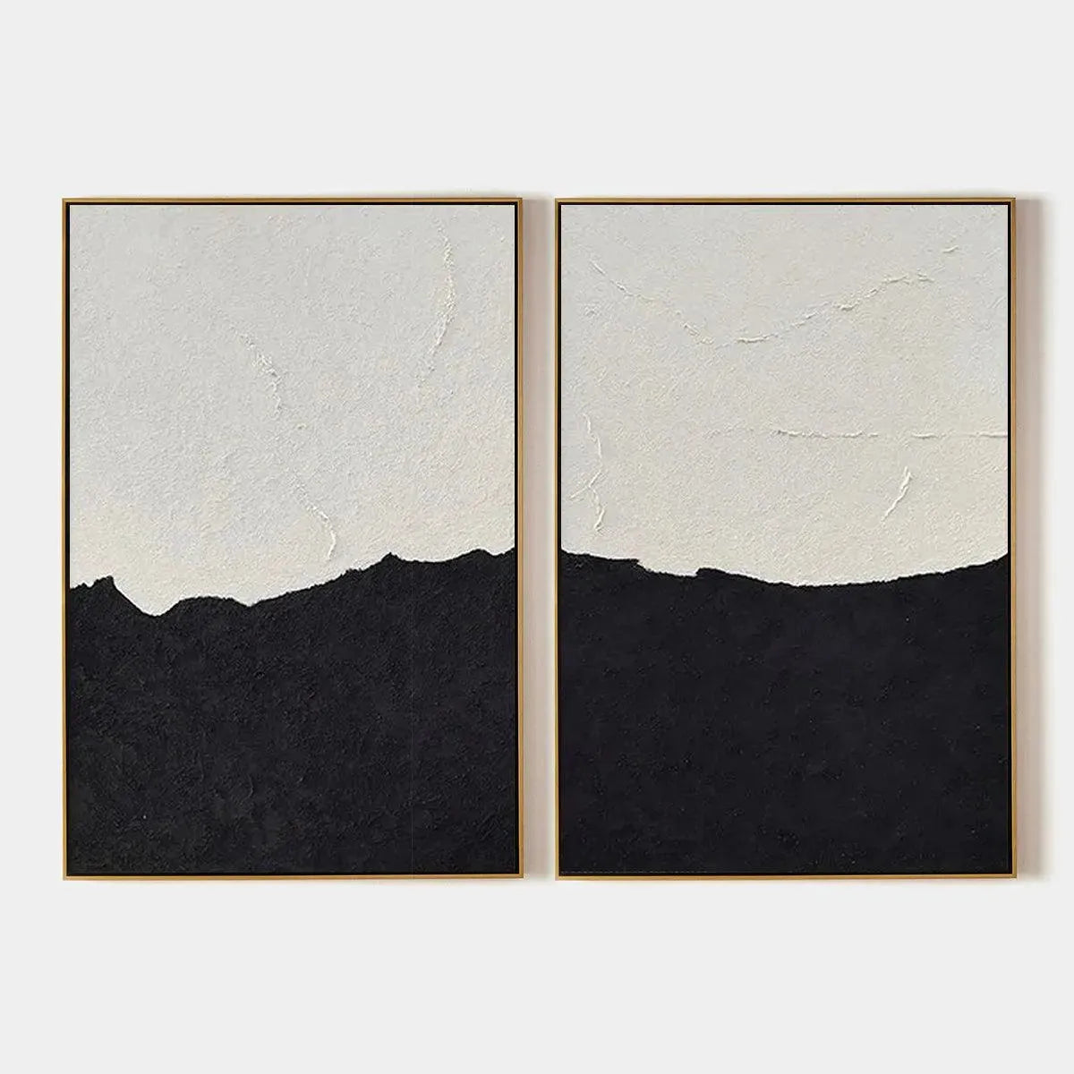 Two minimalist abstract beach paintings in gold frames, black and white canvas art.