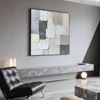 Minimalist abstract canvas art above a marble console table in a modern living room.