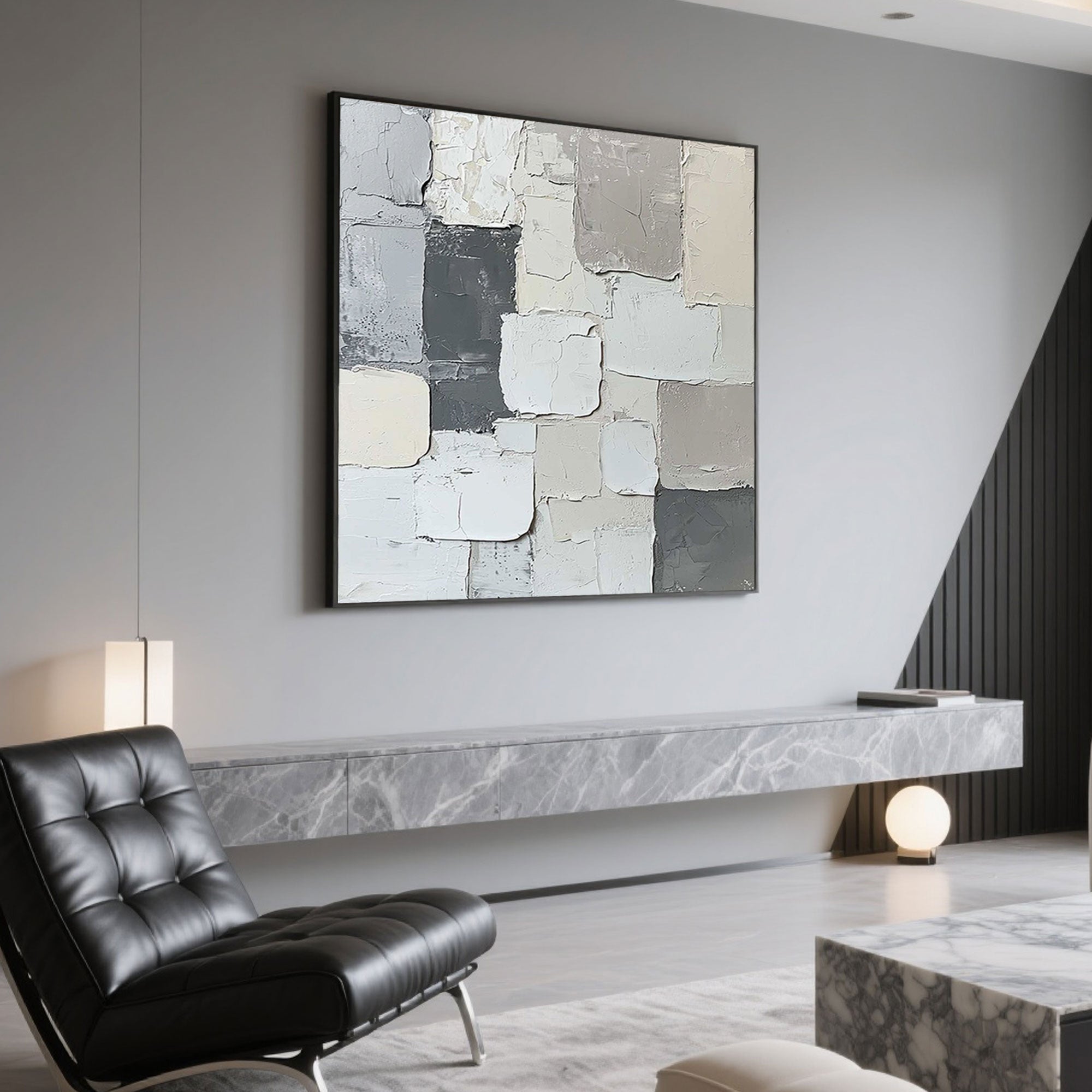 Minimalist abstract canvas art above a marble console table in a modern living room.