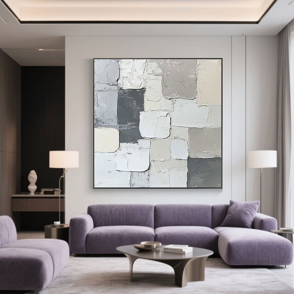 Minimalist abstract canvas art in a modern living room with a purple sofa.