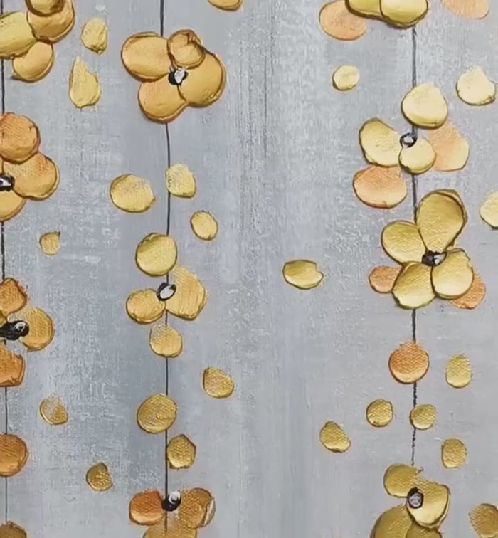Detailed view of golden botanical elements cascading on a grey-white background.