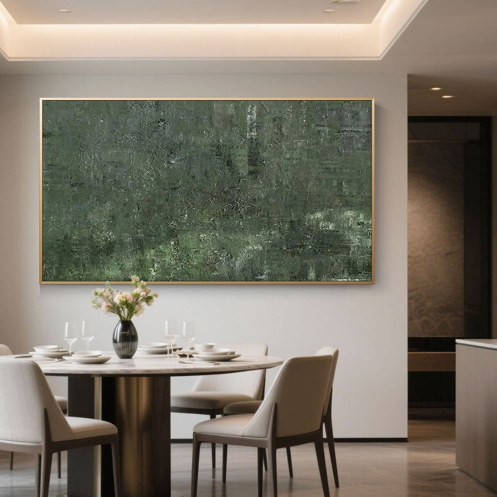 Mossfield green abstract painting with a gold frame in a modern dining room setting.