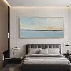 Minimalist horizon art with a gold frame in a modern bedroom setting.
