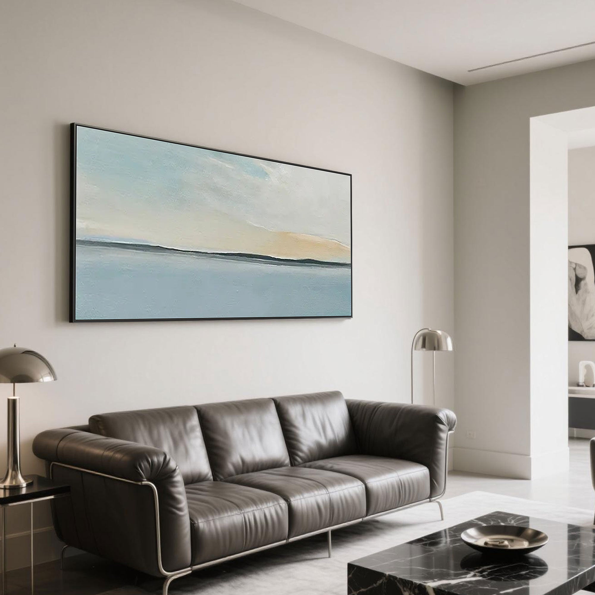 Abstract seascape canvas art with black frame in a modern living room.