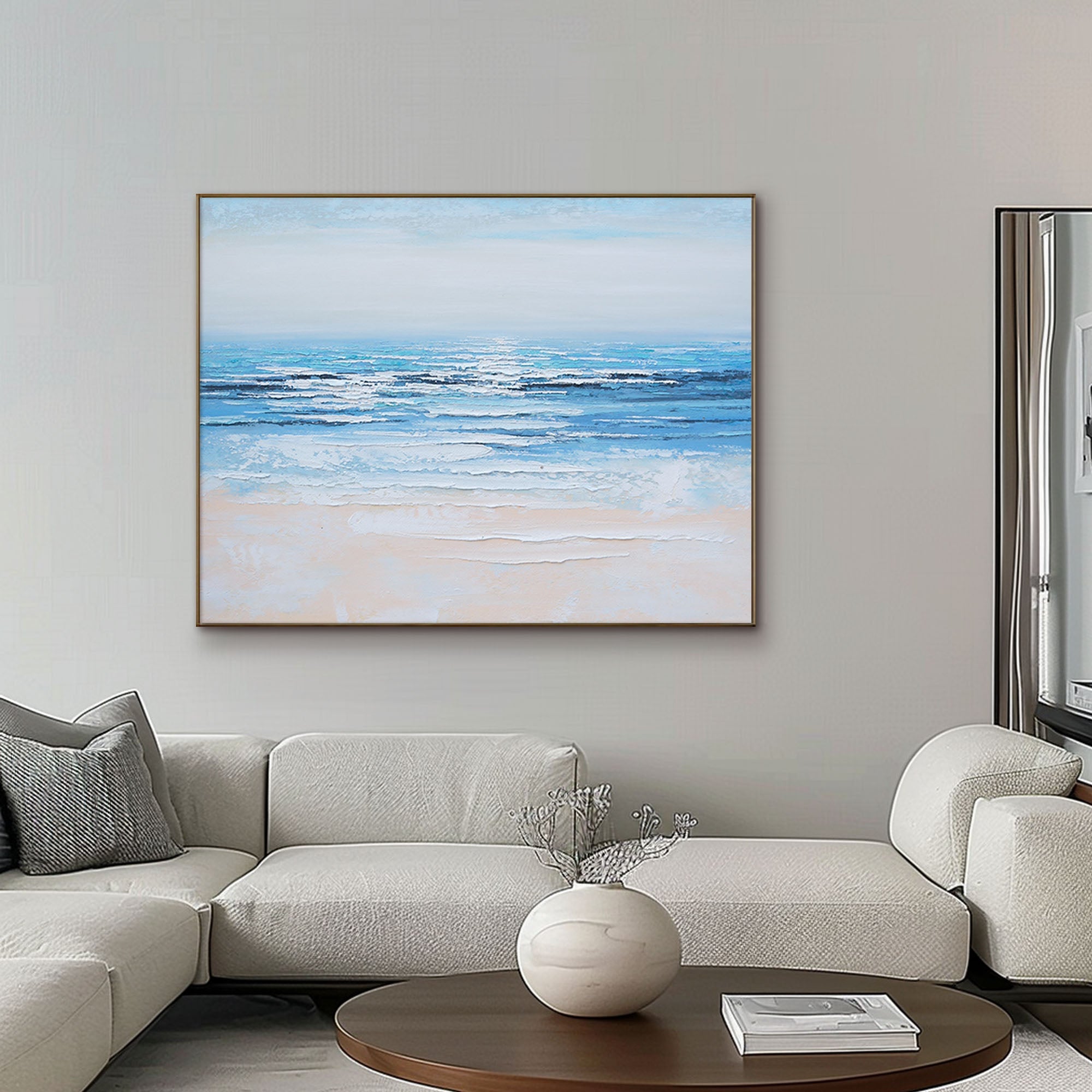 Framed Silent Shore coastal art above a sofa in a modern living room setting.