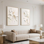 Beige sofa and gold accents compliment minimalist floral canvas art in a modern living space.