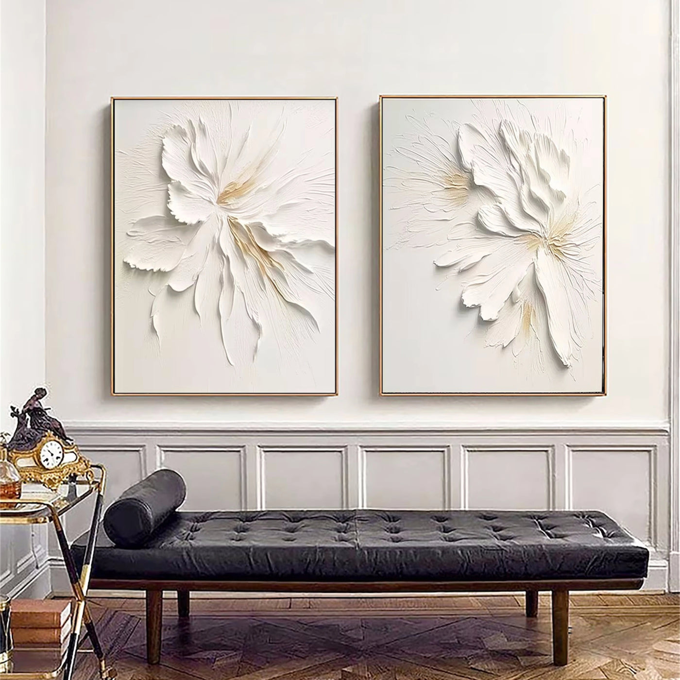 Contemporary living room featuring framed minimalist floral canvas art above a black leather sofa.