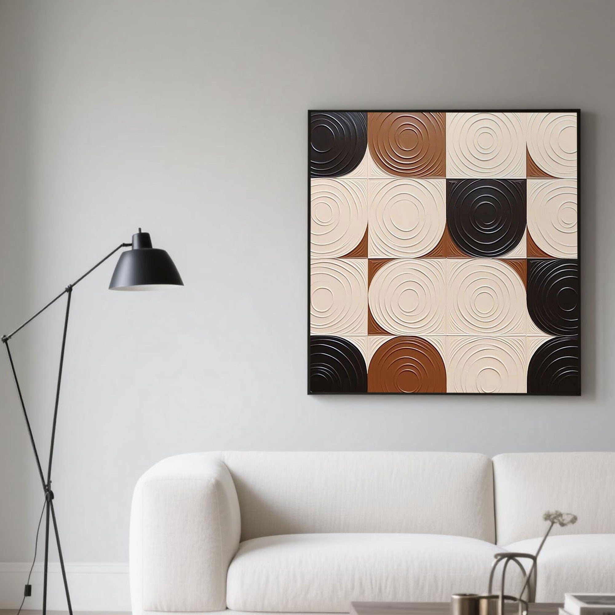 Hand-painted 3D textured geometric canvas art with concentric circles in cream, brown, and black tones, displayed in a bright modern living room with a white sofa and arc floor lamp, highlighting luxury wall decor and environmentally friendly painting materials.