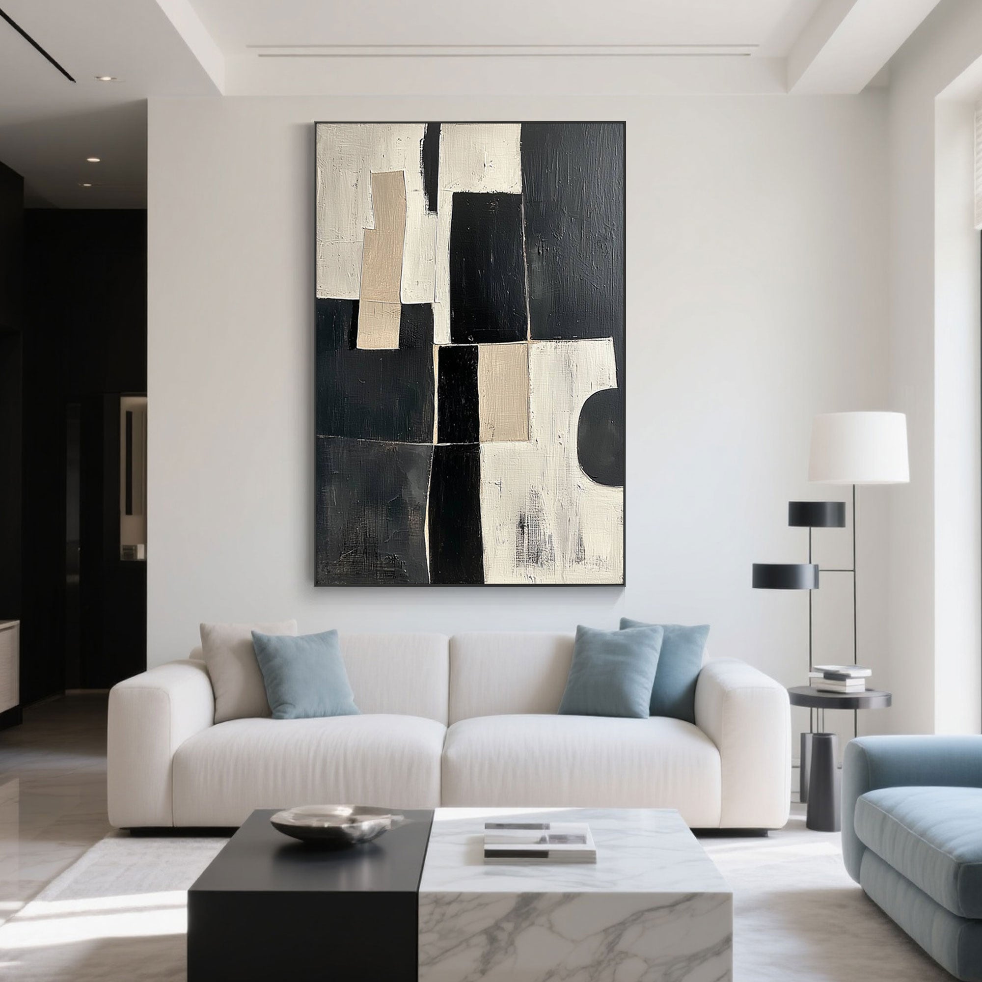 Black and white geometric art above a sofa in a modern living room.