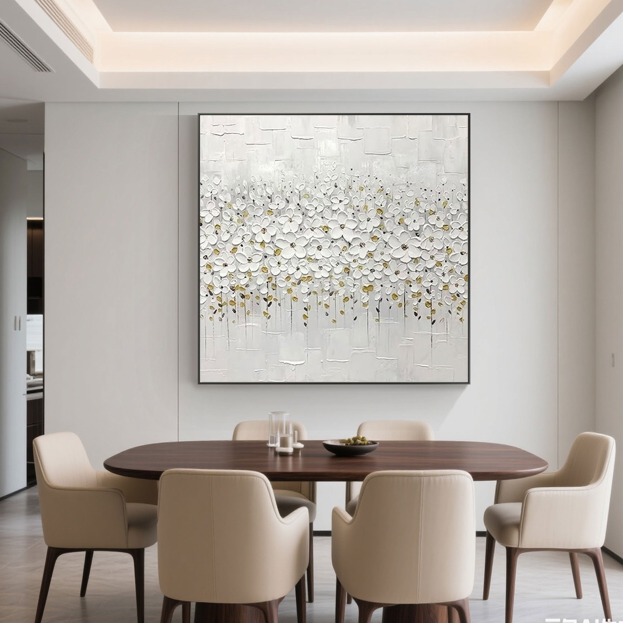 White bloom floral wall art hanging above a cabinet, next to a brown leather chair.
