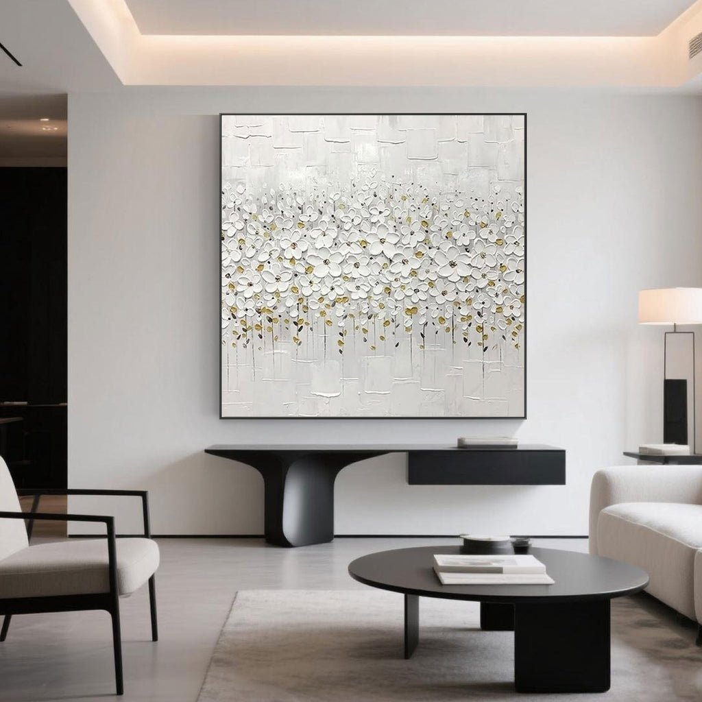 Minimalist white floral canvas art displayed in a modern living room setting.