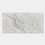 Close-up of minimalist wave wall art with soft, textured white waves.