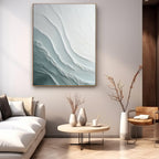 Modern lounge featuring textured blue-white artwork, metal-rimmed table and floor lamp