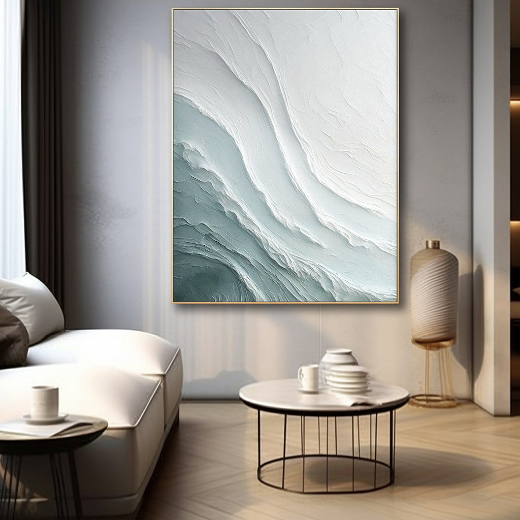 Minimalist living room with abstract wave painting, white sofa and round coffee table in natural light