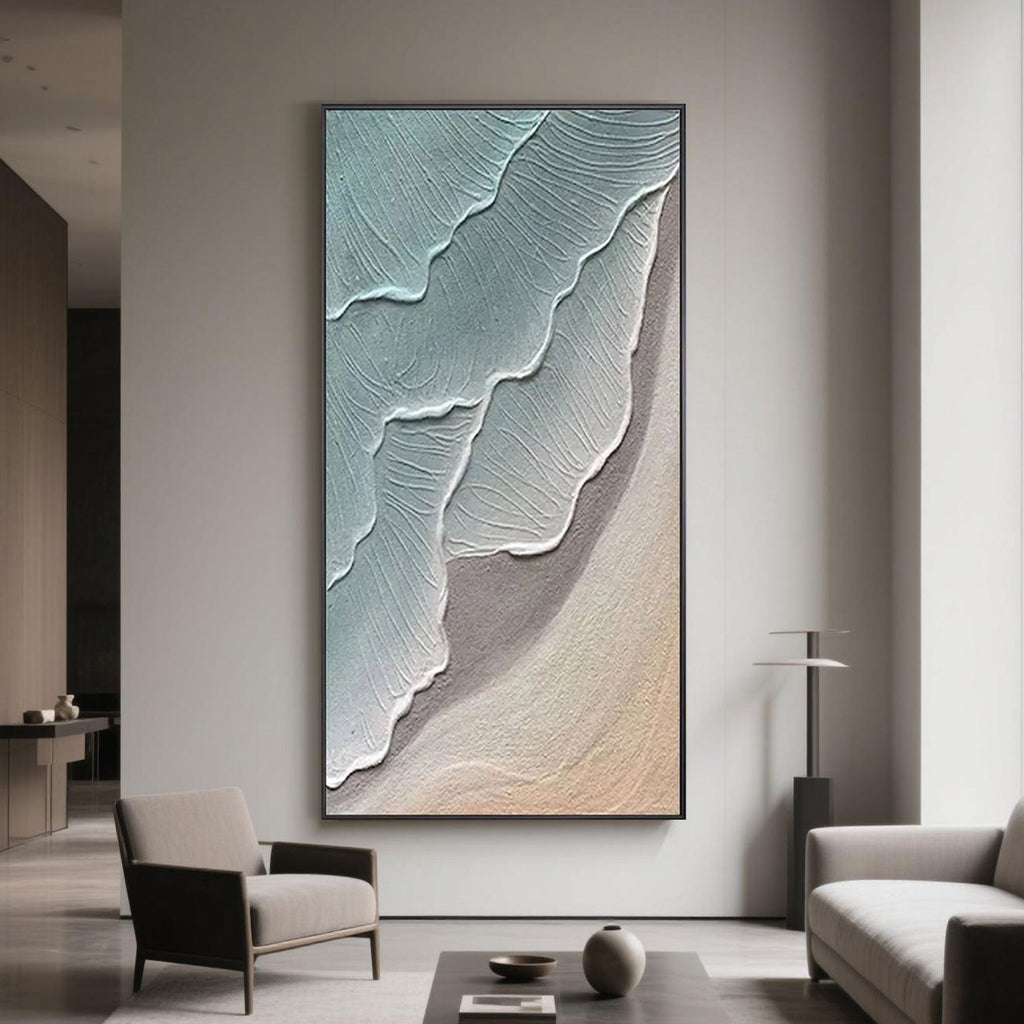 Stylish modern lounge area displaying vertical ocean-themed abstract painting, featuring soothing blue and beige textured waves.