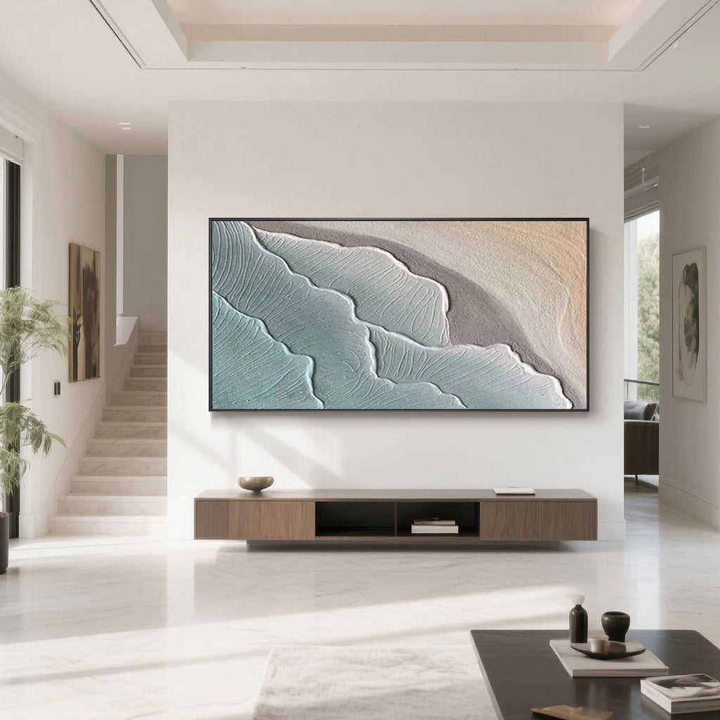 Modern living room featuring minimalist ocean-themed abstract wall art, showcasing hand-painted blue and beige wave textures on canvas.