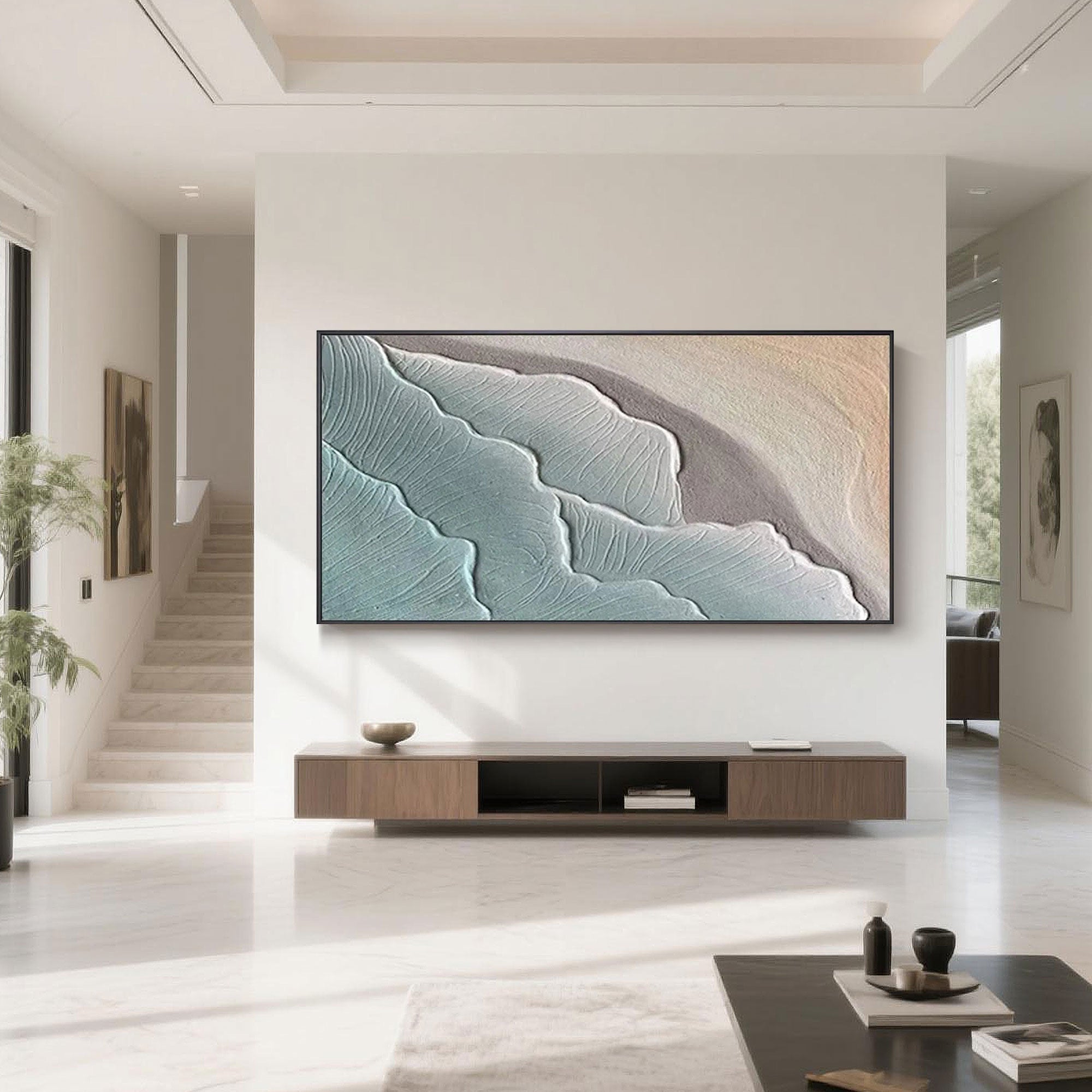 Modern living room featuring minimalist ocean-themed abstract wall art, showcasing hand-painted blue and beige wave textures on canvas.