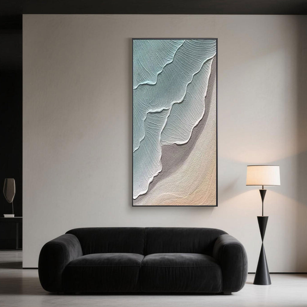 Contemporary living room design accented with a vertical abstract seascape wall painting, hand-painted in minimalist blues and sandy beige.