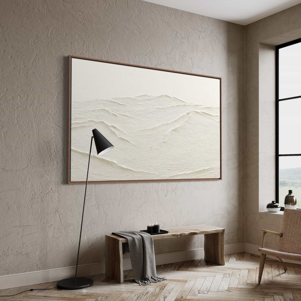 Minimalist textured abstract painting in neutral tones, featuring wave-like mountain ridge patterns, displayed as focal point on light-colored wall