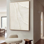 Whitecaps textured painting with a gold frame hanging in a modern living space.