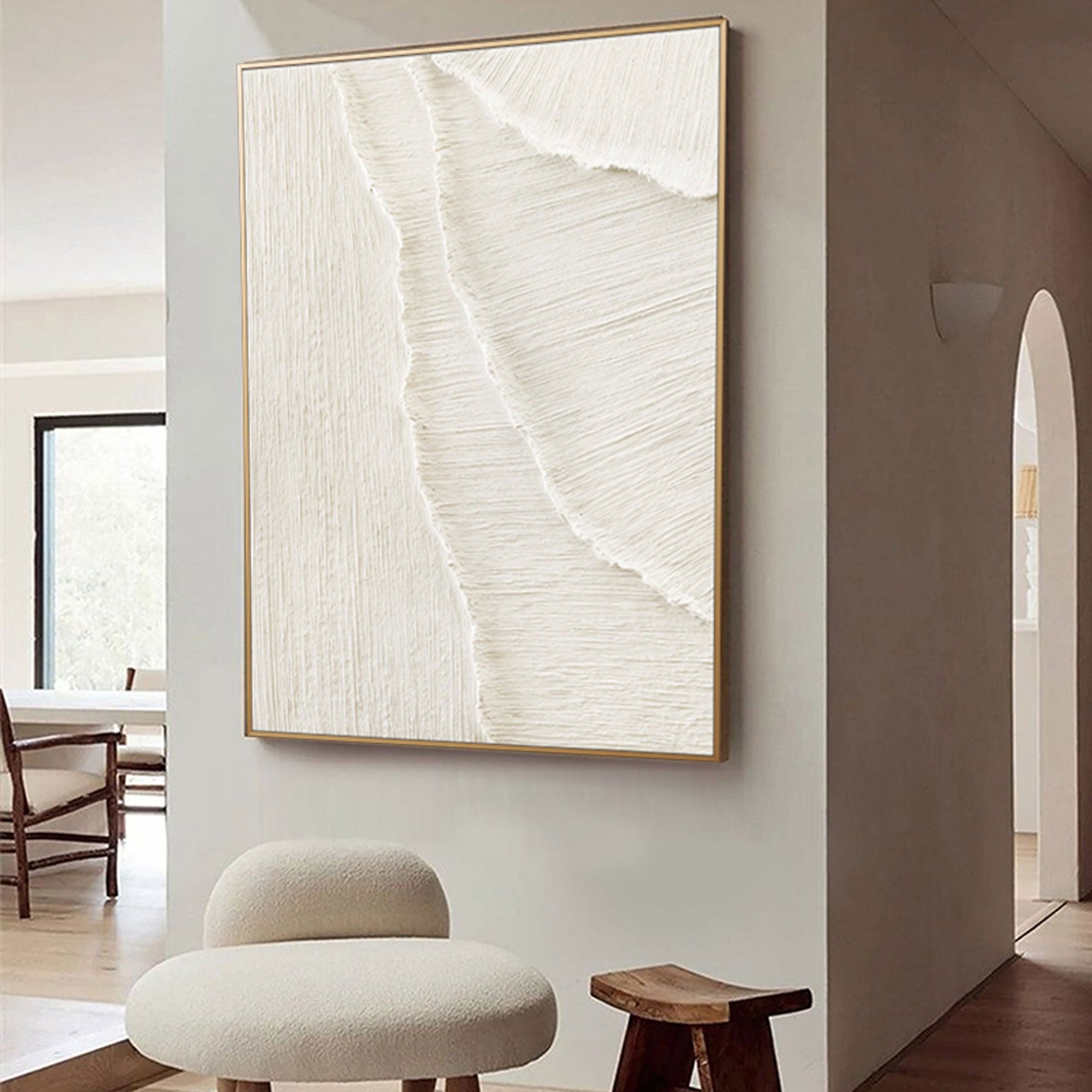Whitecaps textured painting with a gold frame hanging in a modern living space.