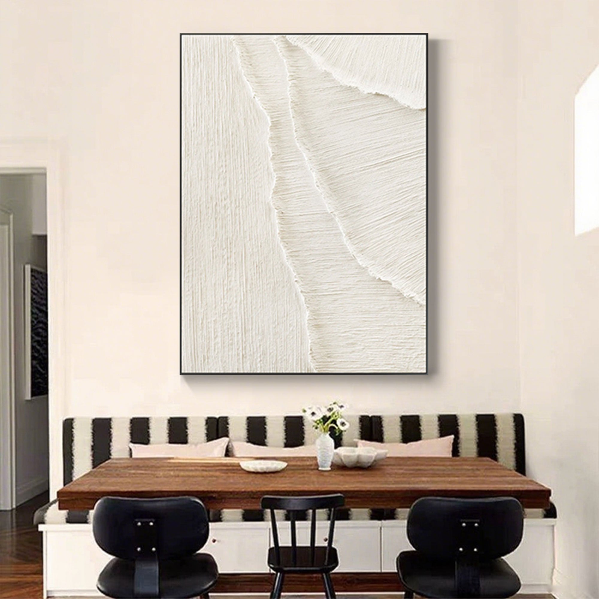 Whitecaps 3D painting with black frame above a dining table.