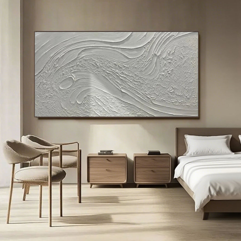 Minimalist textured art in a serene dining room setting with natural light.