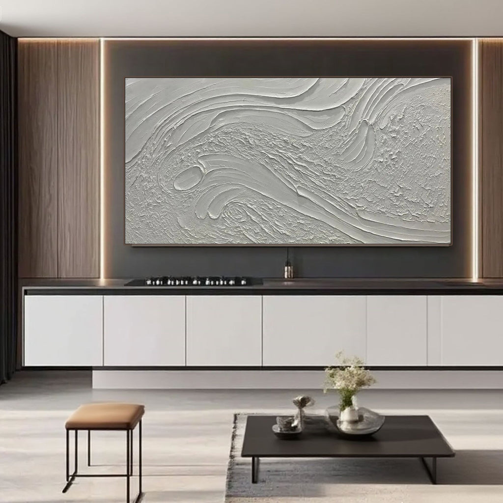Beige and white textured canvas art displayed above a dining room table in a modern interior.