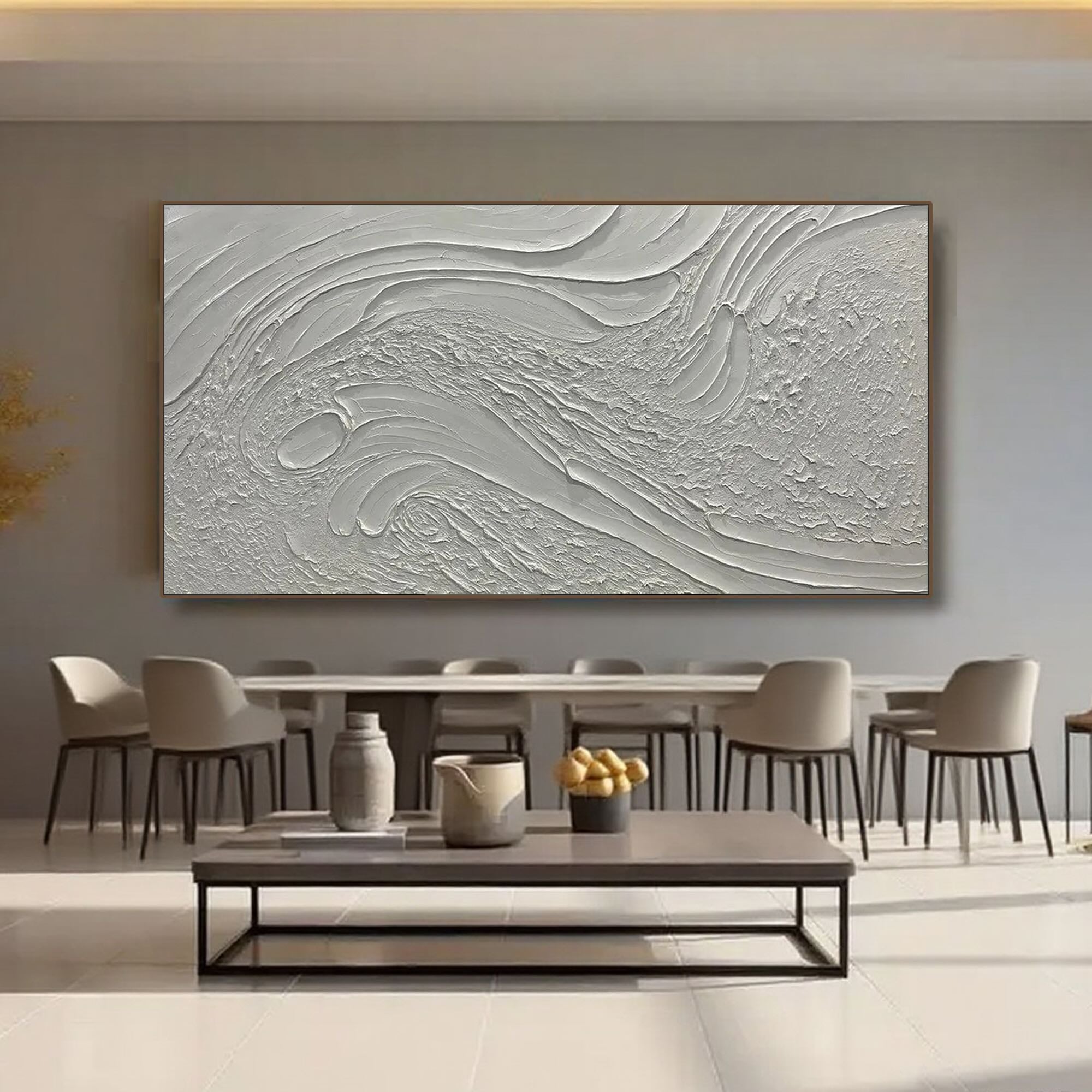 Minimalist textured art in a serene dining room setting with natural light.
