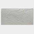 Close-up of a minimalist abstract canvas art with a heavy 3D texture in natural white tones.