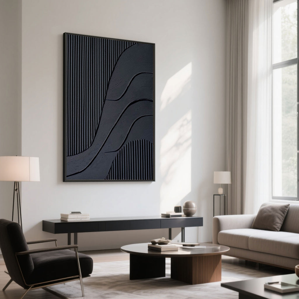 Contemporary living space with black 3D canvas art above a console against white wall.