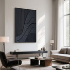 Contemporary living space with black 3D canvas art above a console against white wall.