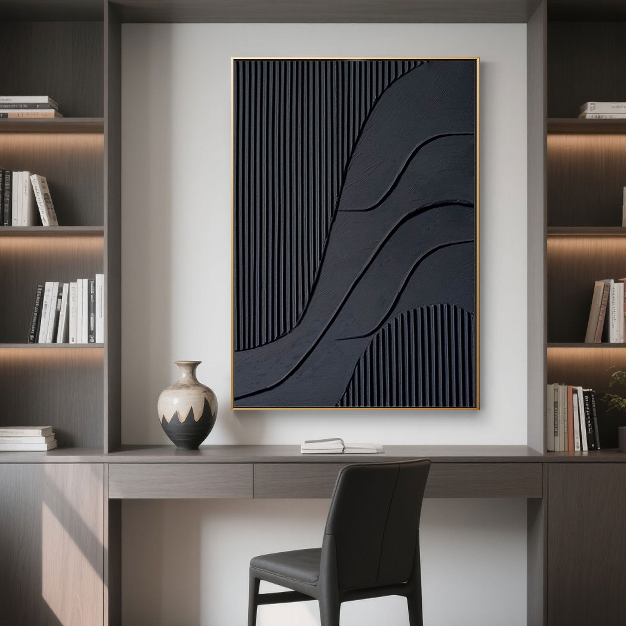 Black 3D canvas art in gold frame displayed above desk with shelves backdrop.