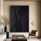 Minimalist geometric 3D textured wall art 'Shadow Lines' in black with curved and linear patterns, displayed in a modern living room.