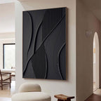 Black minimalist geometric 3D textured wall art with shadow lines by Lumi Gallery, mounted on white wall in modern interior