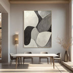 Minimalist geometric abstract canvas art in living room. Black, white, and grey.